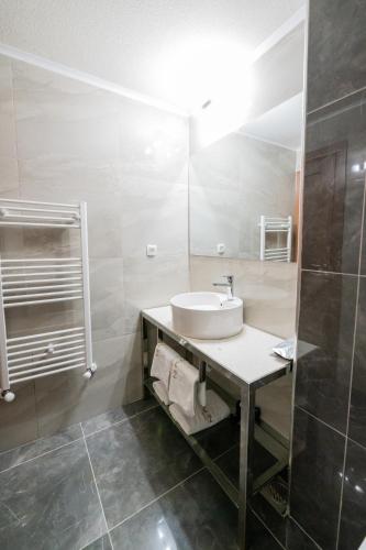 a bathroom with a sink and a mirror at Hotel City IN in Kochani