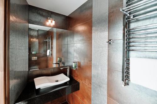 a bathroom with a sink and a shower at Blue Diamond Hotel Active SPA in Rzeszów