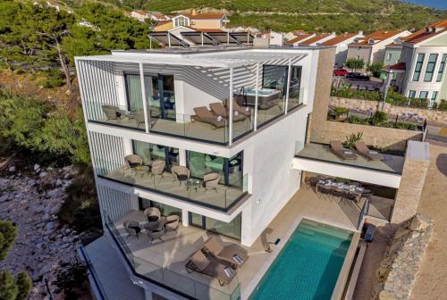 an aerial view of a house with a swimming pool at Luxury Villa Delight II Promajna with pool, gym, sauna and jacuzzi in Promajna