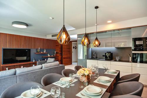 a dining room with a couch and a table and chairs at Luxury Villa Delight II Promajna with pool, gym, sauna and jacuzzi in Promajna