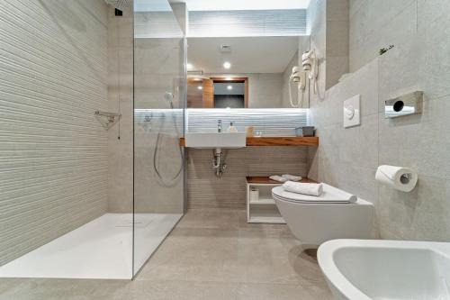 a bathroom with a shower and a toilet and a sink at Luxury Villa Delight II Promajna with pool, gym, sauna and jacuzzi in Promajna