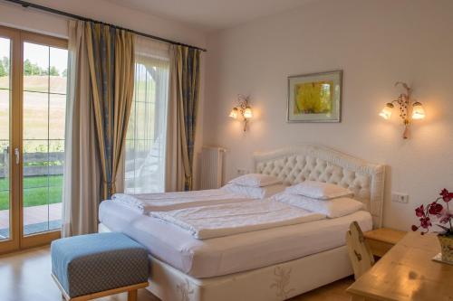 sypialnia z białym łóżkiem i balkonem w obiekcie Abanico Appartements w mieście Seefeld in Tirol
