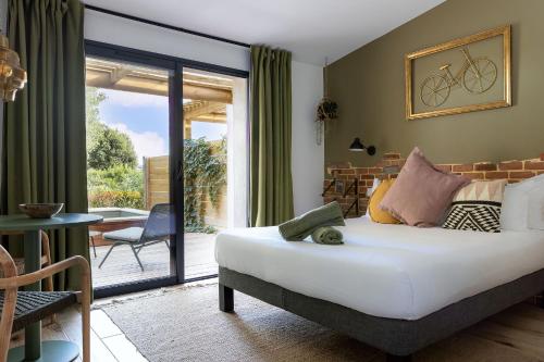 a bedroom with a bed with a bike on the wall at Résidence Casarina in Bonifacio