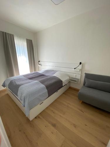 מיטה או מיטות בחדר ב-Ferienwohnung Weingut Höllerer