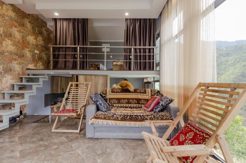 a bedroom with a bunk bed and two chairs at Vaio Resort in Keda in Keda