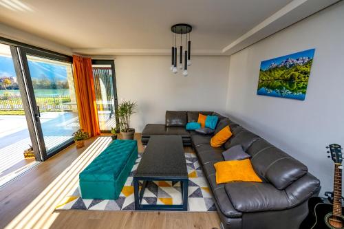 a living room with a leather couch and a table at Villa Nera - Etwa in Mostar
