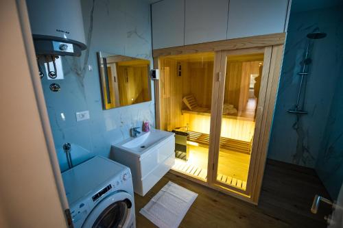 a bathroom with a sink and a washing machine at Villa Nera - Etwa in Mostar