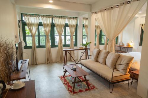 a living room with a couch and a bed at Big Tree Boutique Hotel in Koh Tao