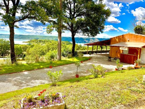 a view of a house with a garden at LES BASTIDES DE CHANTERAINE Bungalows, Lodges & Spa in Aiguines