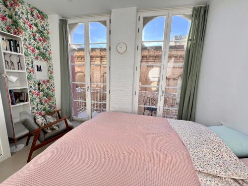 a bedroom with a pink bed and a window at Beautiful house in Cartagena's historic center in Cartagena
