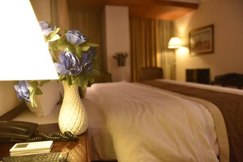 Cama o camas de una habitación en Shalimar Tower Hotel Lahore