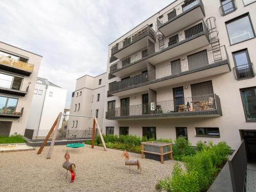 a playground in front of a apartment building at Limehome Passau Bahnhofstraße in Passau