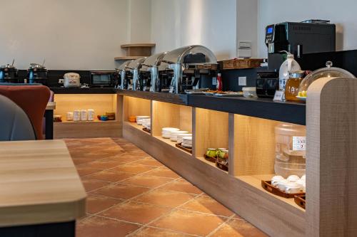 a kitchen with a counter with food on it at 花蓮晨風星語民宿Sun Star B&B in Jian