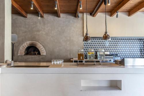a kitchen with a counter with a brick oven at Eden Roc Resort - All Inclusive in Kallithea Rhodes