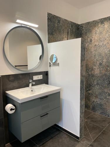 a bathroom with a sink and a mirror at Meine Schule Sehlingen, stilvollem Studio auf dem Land in Kirchlinteln