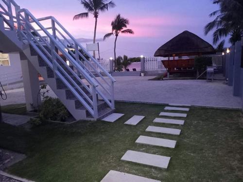 a staircase leading up to a house with the beach at Maykenn Beach in Bantayan Island