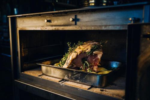 a turkey is being cooked in an oven at Delina Mountain Resort in Anogia