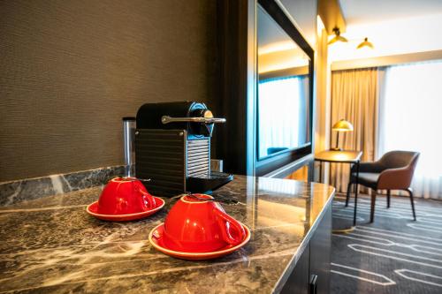 two red bowls on a counter in a hotel room at Crowne Plaza Sydney Airport by IHG in Sydney