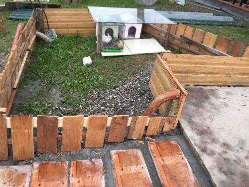 a wooden bench in a yard with a bird house at Haibian Mingren 50 in Hualien City