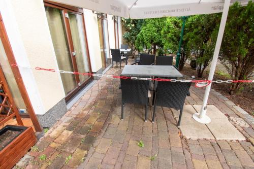a table and chairs on a patio with an umbrella at Boutique Hotel Sena in Berlin