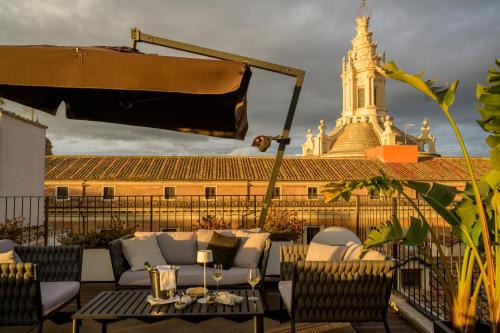 a patio with a couch and a table and a building at Palazzo Navona Hotel in Rome