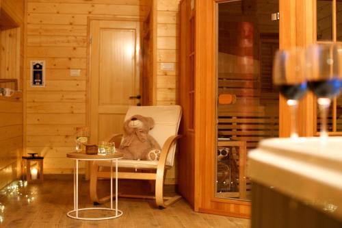 a teddy bear sitting in a chair in a room at Holiday Home Mali Medo in Gospić