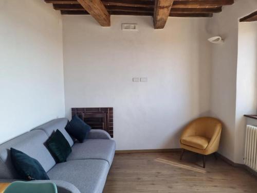 a living room with a couch and a chair at Tuscany boutique apartment in Manciano