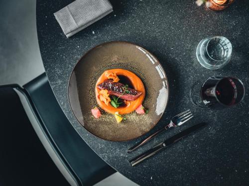 a bowl of food on a table with a plate of food at Hôtel LÉONOR the place to live in Strasbourg