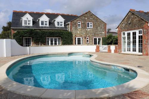 a large swimming pool in front of a house at Rookley Farm Lodge - Pet friendly in Rookley