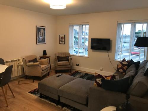 a living room with a couch and a flat screen tv at Central town location apartment in Enniscorthy
