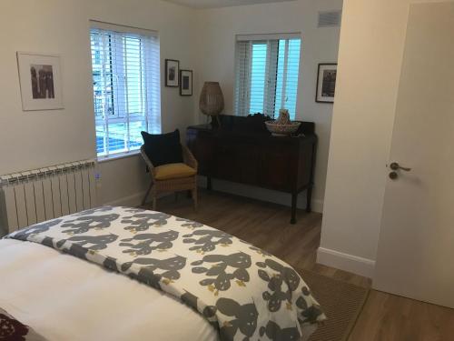 a bedroom with a bed and a desk and a chair at Central town location apartment in Enniscorthy