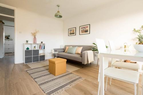 a living room with a couch and a table at Stylish apartment with balcony, minutes from beach in Redcar