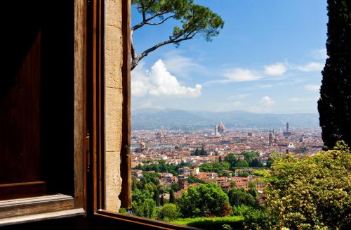 a view of a city from a window at Hotel Torre di Bellosguardo in Florence