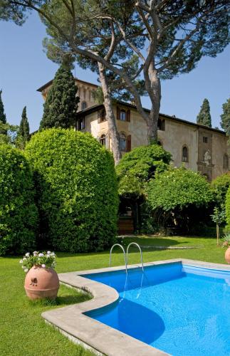 a swimming pool in the yard of a house at Hotel Torre di Bellosguardo in Florence