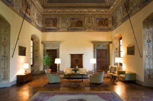 a living room filled with furniture and a large window at Hotel Torre di Bellosguardo in Florence