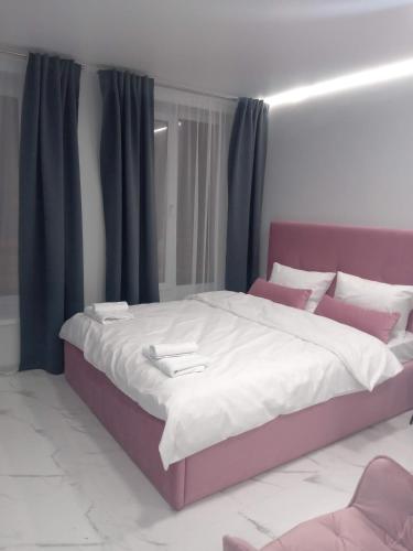 a bedroom with a large bed with purple curtains at 39 Apart Hotel in Lviv