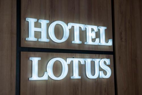 a sign that says hotel louis on a wooden wall at Lotus Hotel Chisinau in Chişinău