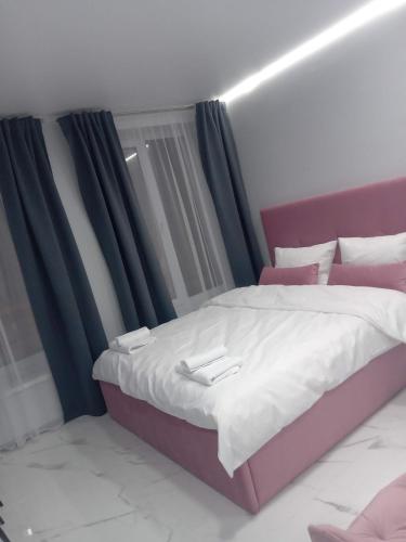 a bedroom with a large bed with purple curtains at 39 Apart Hotel in Lviv