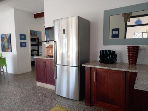 a kitchen with a stainless steel refrigerator in a room at Ocean rush barracuda in Zinkwazi Beach