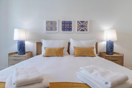 a bedroom with a large white bed with two lamps at Stunning Apartment in Heart of Lisbon by LovelyStay in Lisbon