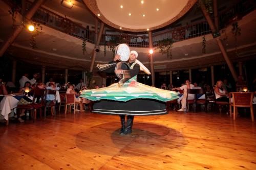 a woman is dancing in a dress on a dance floor at Seagull Beach Resort - Families and Couples Only in Hurghada