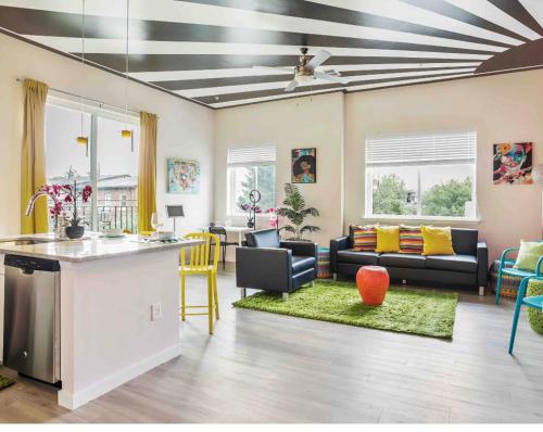 a living room with a kitchen and a living room with a table at Lux House Of Champagne 2BR 2BA Free Parking & Wifi in Baltimore