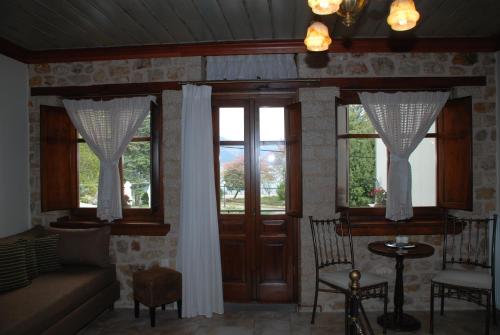 a living room with a couch and two windows at Siarava in Ioannina