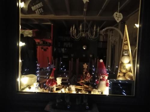 a mirror with christmas trees and christmas lights at Chalet La Bachole in Charancieu