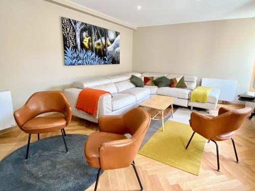 a living room with a white couch and chairs at Capella YourHostHelper in Caen