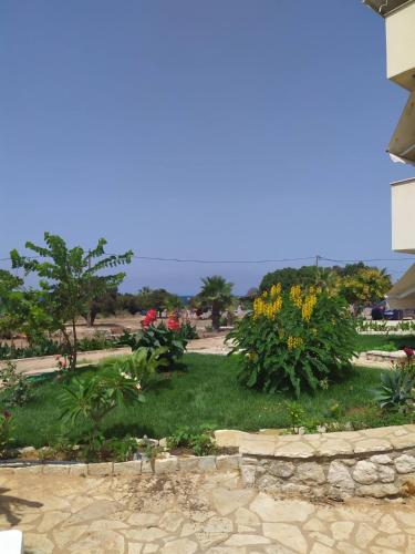 a view of a garden with flowers and trees at Sea & Sky by Marisa in Petrokhorion