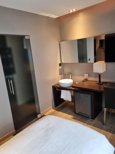 a bathroom with a sink and a mirror at Skol l'Original in Luxembourg