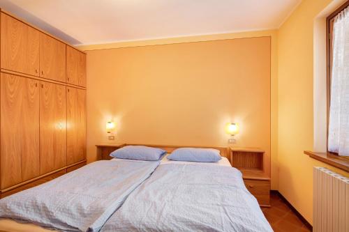 Ένα ή περισσότερα κρεβάτια σε δωμάτιο στο Chalet Meridiana Appartamento 3