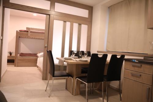 a kitchen and dining room with a table and chairs at Apartments Slap in Slappe dʼIdria