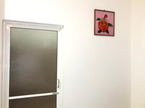 an open door with a picture on the wall at Jilan Homestay in Bentota